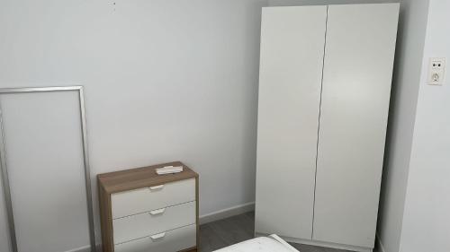 a bedroom with two tall cabinets and a mirror at Apartamento con terraza sol y montaña tranquilidad in Málaga