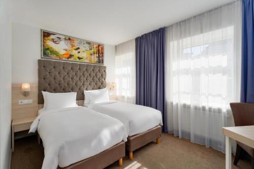 Postel nebo postele na pokoji v ubytování Radisson Hotel Old Town Riga