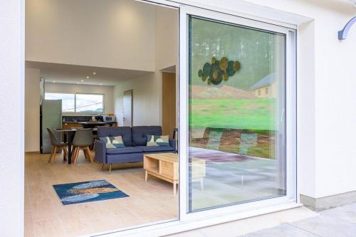 a living room with a large sliding glass door at Ma Bonne Etoile in Anould