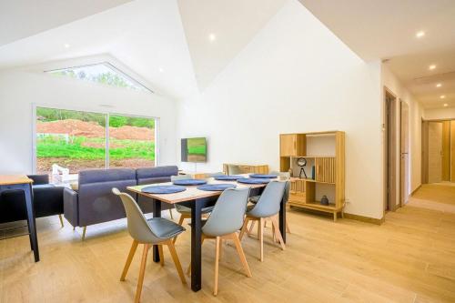 a dining room with a table and chairs at Ma bonne étoile in Anould