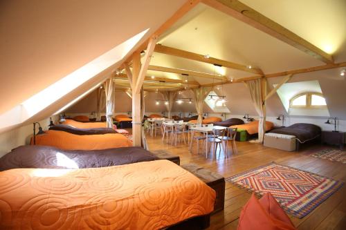 a room with a bunch of beds in a tent at Csodarabbik Útja Fogadó in Mád