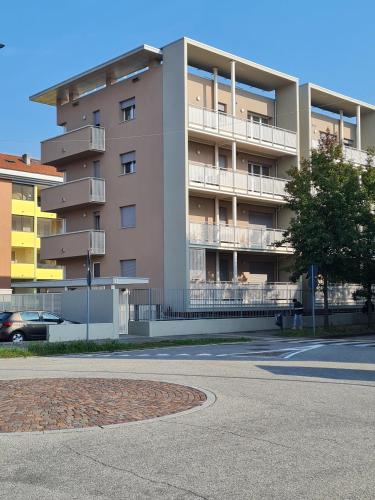 an apartment building with a parking lot in front of it at Casa Michele 7 in Pregnana Milanese