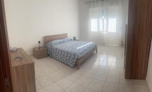 a bedroom with a bed and a tiled floor at Casa paradiso in Vasto