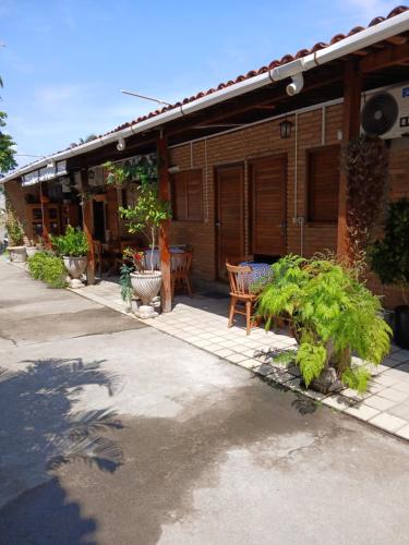 a house with a table and chairs in front of it at Aluguel de suítes praia do frances in Marechal Deodoro