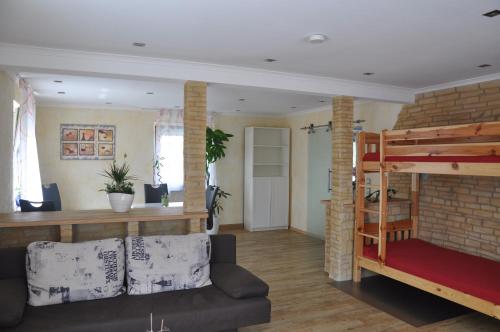 a living room with a bunk bed and a couch at Kiefer-Apartments in Rust