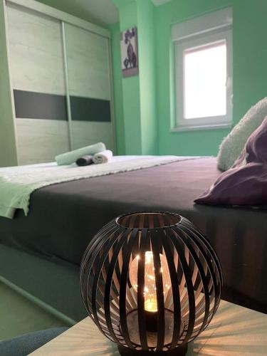 a bedroom with a bed and a lamp on a table at Mostar Luxury Apartment in Mostar