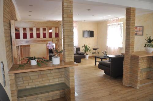 a living room with a fireplace and a couch at Kiefer-Apartments in Rust