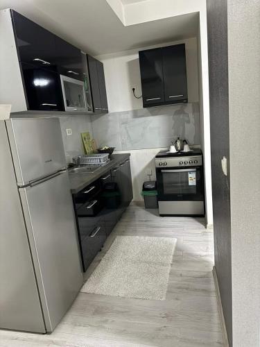 a kitchen with a refrigerator and a stove at Mostar Luxury Apartment in Mostar