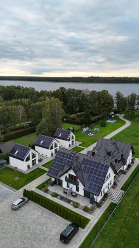 an aerial view of a house with solar panels on it at Apartamenty Zielona Lipka in Pisz