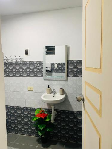 a bathroom with a sink and a mirror at HOSPEDAJE don VICTOR in Chancayllo