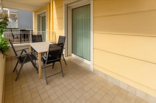 a patio with a table and chairs on a balcony at Residence Antares in Riccione
