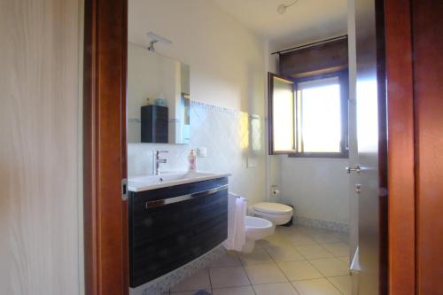 a bathroom with a sink and a toilet at Casa di Stefy in Quartu SantʼElena