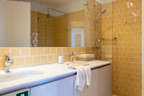 a bathroom with a sink and a shower at Casa Azul Santa Marinha in Vila Nova de Gaia