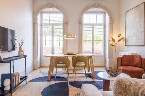a living room with a table and chairs at Casa Azul Santa Marinha in Vila Nova de Gaia