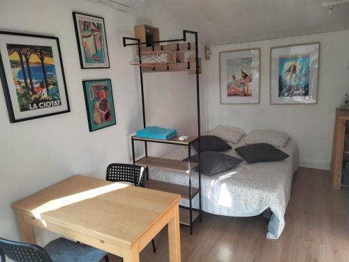 a room with a bed and a table in it at Chalet Nanou in La Ciotat