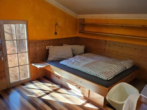a bed in the corner of a room at Haus Johanna in Wenns