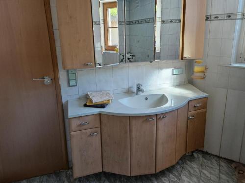 a bathroom with a sink and a mirror at Haus Johanna in Wenns
