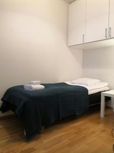 a bed in a small room with white cabinets at Convenient Studio for 1 with Sauna in Kemi