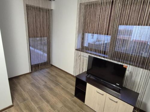 a living room with a flat screen tv on a stand at BVA&Studio 