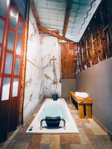 a bathroom with a bath tub in a room at Glamping Villa Pedregal in La Gran Via