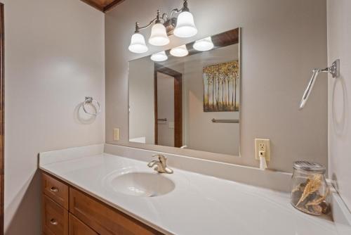 a bathroom with a sink and a large mirror at Banner Elk Lodge in Beech Mountain
