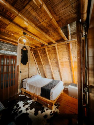 a bedroom with a bed in a wooden ceiling at Glamping Villa Pedregal in La Gran Via