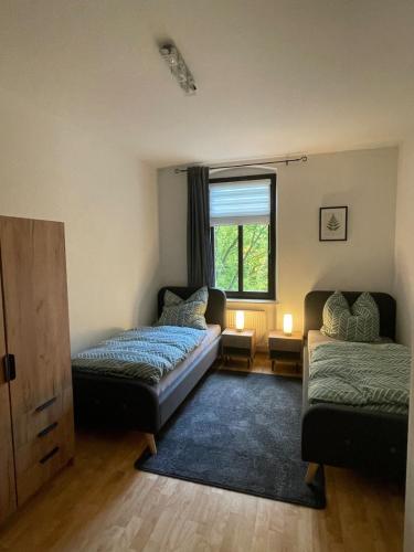 a living room with two beds and a window at Moderne Wohnung für 4 Personen in Zeitz