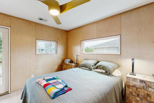a bedroom with a bed and a ceiling fan at Intracoastal Indulgence in Holden Beach