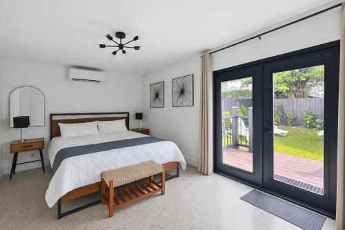 a bedroom with a bed and a sliding glass door at Private King Suite in Miami in Miami