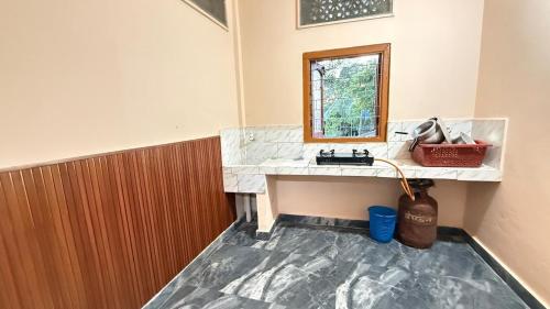 a bathroom with a sink and a mirror at Royal Palace in Dibrugarh