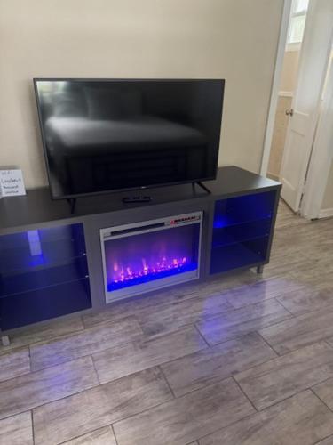 a flat screen tv sitting on top of a entertainment center at Lazy Oaks Resort Cottages in Leesburg