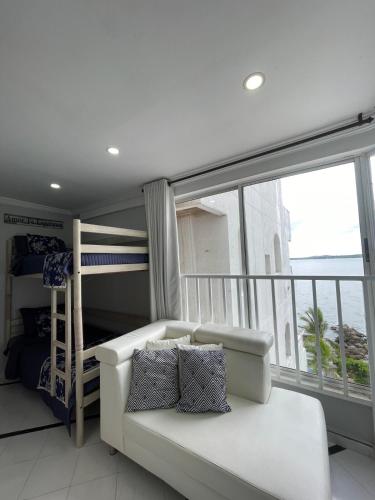a living room with a couch and a bunk bed at Loft in Cartagena with direct beach access in Cartagena de Indias
