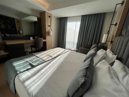 a large white bed in a hotel room at Side Zeugma Hotel - Adult Only 16 Plus in Side