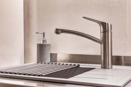 a kitchen sink with a faucet and a keyboard at Casa Saba Trieste Family Apartment in Trieste