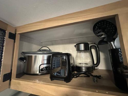 a kitchen counter with a toaster and a coffee maker at Coyote Crossing Tiny Home in Interior