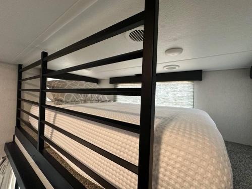 a bedroom with a large bed in a room at Coyote Crossing Tiny Home in Interior