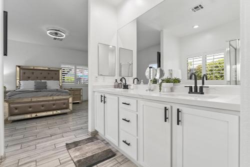 Baño blanco con 2 lavabos y 1 cama en Empire Polo Grounds Close Gorgeous pool and spa home bike to Coachella, en Coachella