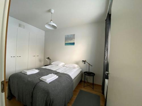 a bedroom with a bed with two towels on it at Modern Apartment for 2 with Sauna in Kemi