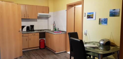a small kitchen with a table and a dining room at Villa Amilia - Ferienwohnung 2 in Waren