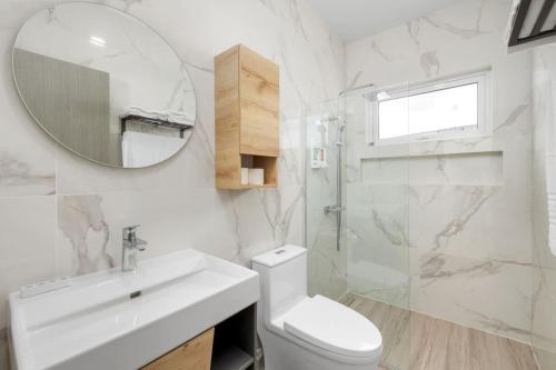 a bathroom with a toilet and a sink and a mirror at Dreamy Getaway w/ Private Pool | BBQ |5min Airport in Tanki Lender