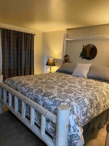 a bedroom with a large bed with a large bedspread at Cozy Bear Condo in Brian Head