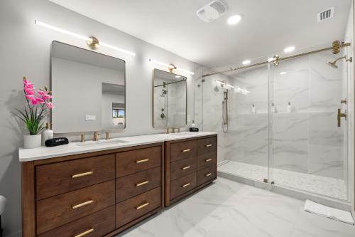 a bathroom with a shower and a sink and a mirror at Dockside Oasis & Private Beach - Hot Tub - Jet Ski in Tampa