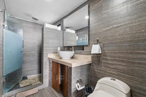 a bathroom with a toilet and a sink at Casa Oasis B-Nayar Gated, Beach Club, Free Shuttle in Cruz de Huanacaxtle
