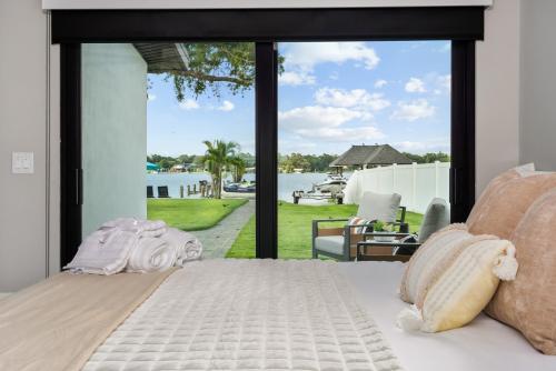 a bedroom with a bed and a view of the water at Dockside Oasis & Private Beach - Hot Tub - Jet Ski in Tampa