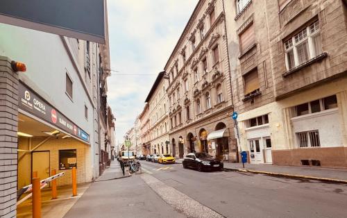 una calle de la ciudad con edificios y un coche en la carretera en Opera Central Stay, en Budapest