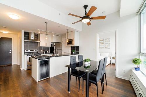 a kitchen and dining room with a table and chairs at Home in the Sky with Gorgeous Water Views in Vancouver