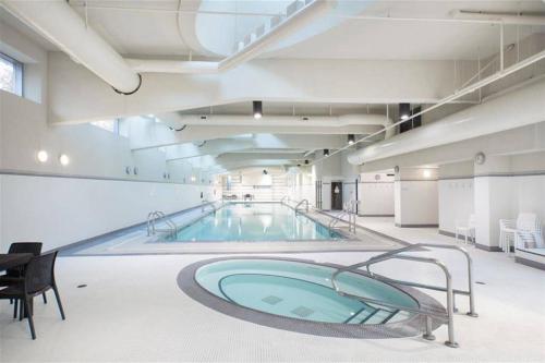 a large swimming pool in a large room with a swimming pool at Home in the Sky with Gorgeous Water Views in Vancouver