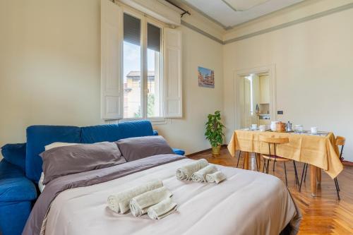 a bedroom with a blue bed with towels on it at XIIGiugno Boutique in Bologna