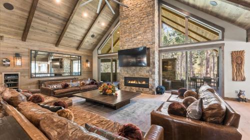 a living room with leather furniture and a fireplace at South Lake Escape Indoor Pool plus Movie Theater in Bijou