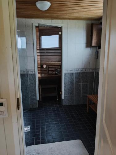 a bathroom with a walk in shower and a sink at Villa Tolonen in Talosenkylä